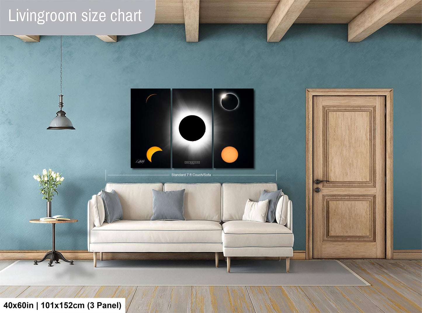 The image is a living room with a white sofa, a wooden door, and a large wall art depicting the solar eclipse. The living room has a blue wall and a wooden floor.