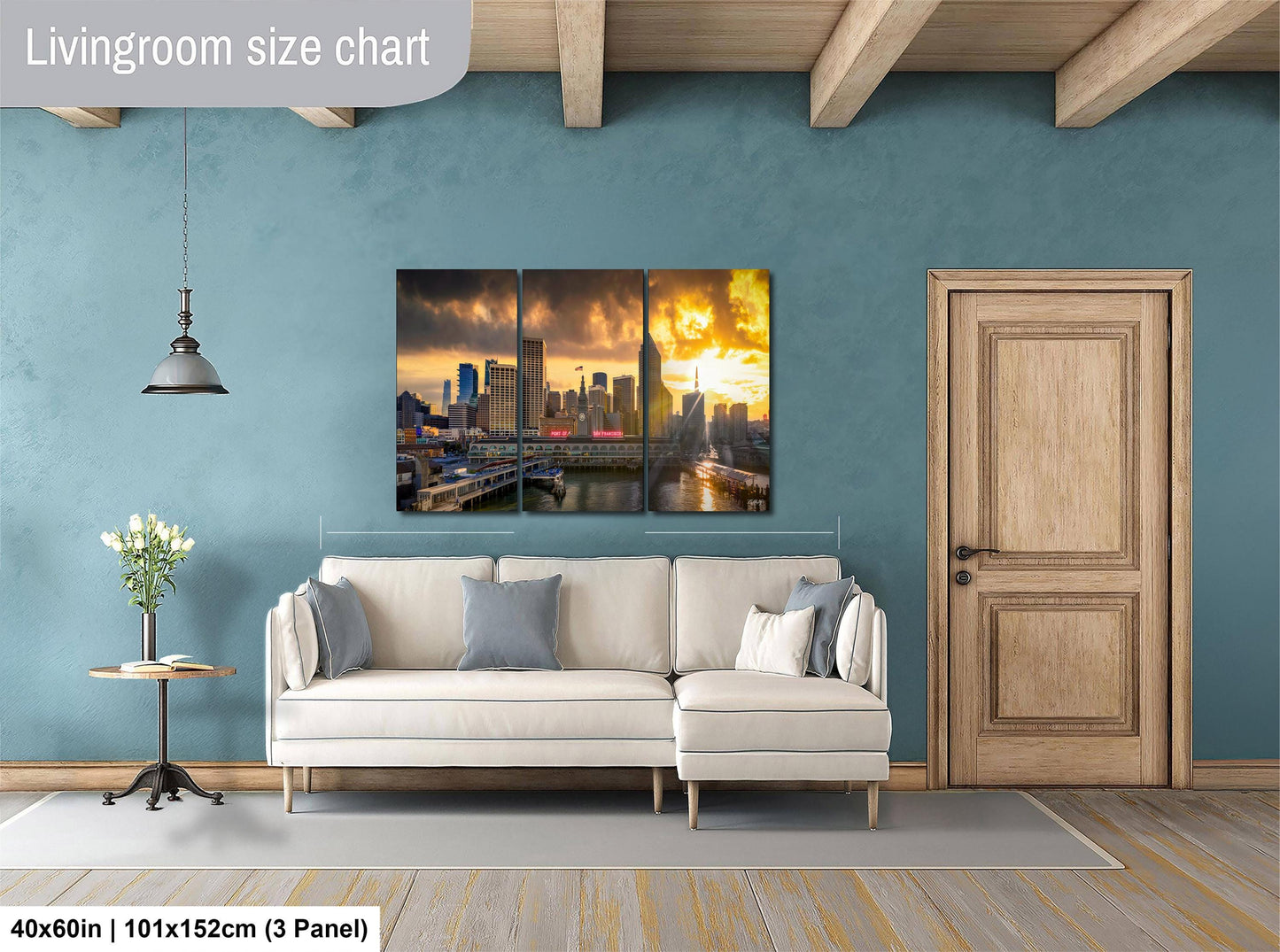 The image is a living room with a large white sofa, a wooden door, and a painting of a city skyline on the wall.