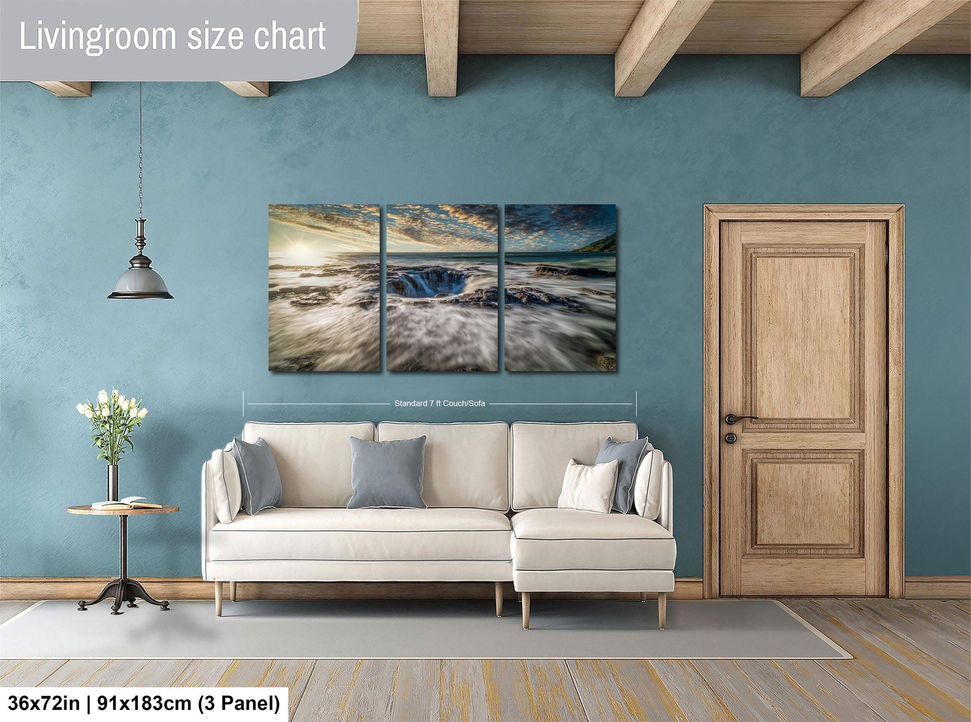 The image is a living room with a large white sofa, a wooden door, and a painting of a landscape on the wall.