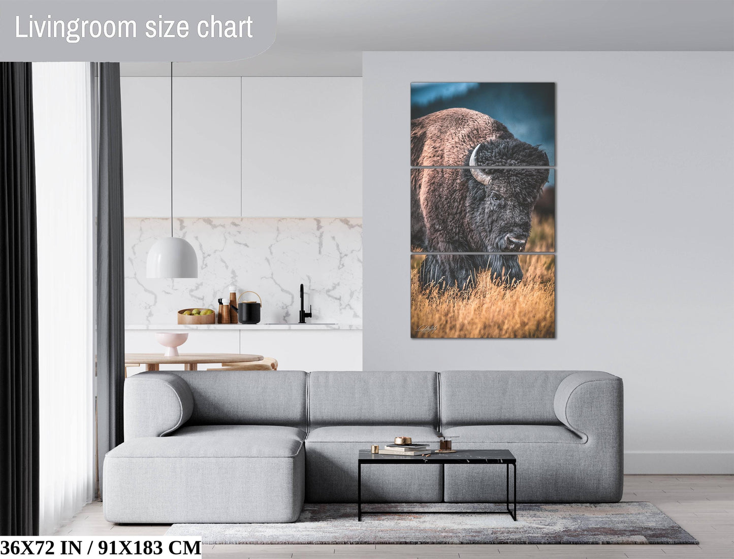 The image is a living room with a gray sofa, a coffee table, and a large wall art depicting a bison in a field.