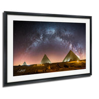 the iconic pyramids of Giza in Egypt, illuminated against a starry night sky.