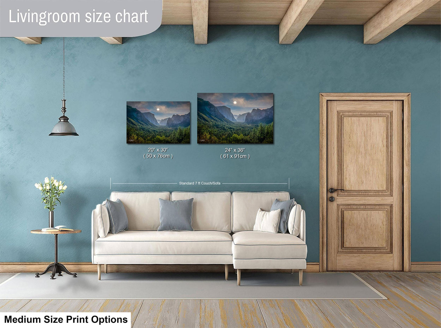 a living room with a white sofa, a wooden door, and a painting of a mountain landscape on the wall.