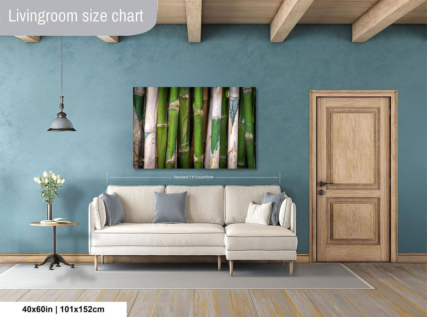 a living room with a white sofa, a wooden door, and a painting of bamboo on the wall.