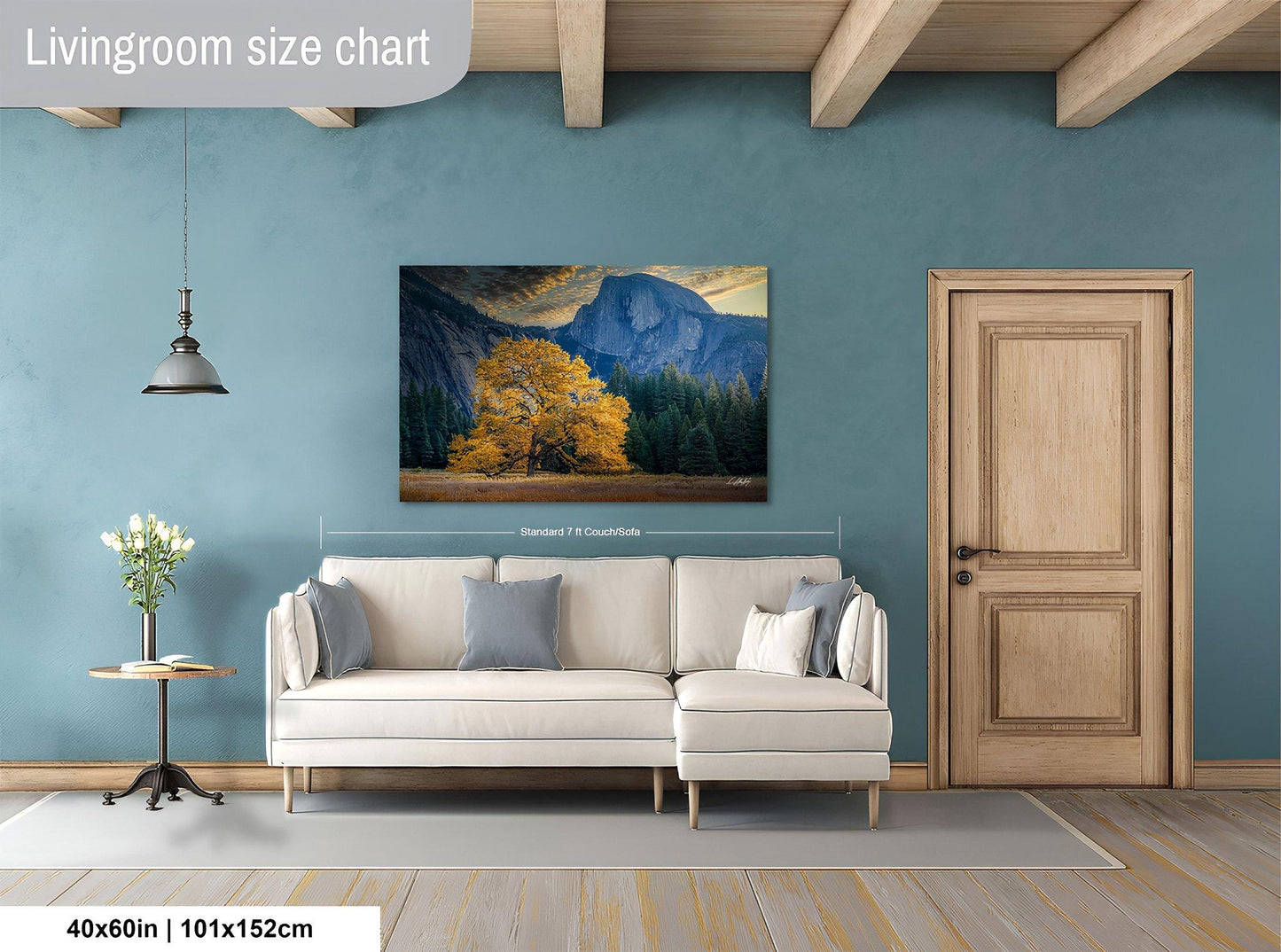 a living room with a large painting of a mountain landscape hanging on the wall. The painting is framed in a white frame and measures approximately 40 inches by 101.5 inches in width and height.