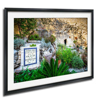 A framed photograph of a stone wall with a sign that reads "Jesus Christ declares with power the Son of God, the Restoration of the Dead".