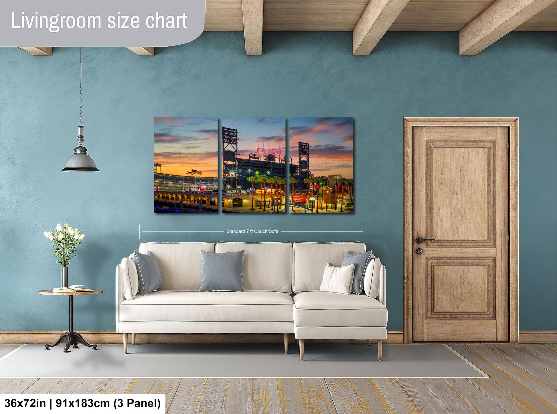 The image is a living room with a large, colorful painting of a city skyline hanging on the wall. The painting is divided into three panels, and the living room has a white sofa and a wooden door.