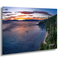 a serene lake at sunset, with a small sailboat gently floating on the calm waters. The sky is filled with vibrant hues of orange and pink, creating a stunning backdrop for the tranquil scene. The lake is surrounded by lush green trees and rocky cliffs, adding to the picturesque landscape. The image is a captivating representation of nature's beauty and the peacefulness of the moment.