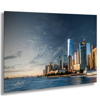 A panoramic view of the New York City skyline, with the One World Trade Center prominently visible among the surrounding skyscrapers. The sky is filled with clouds, creating a dramatic backdrop for the cityscape.