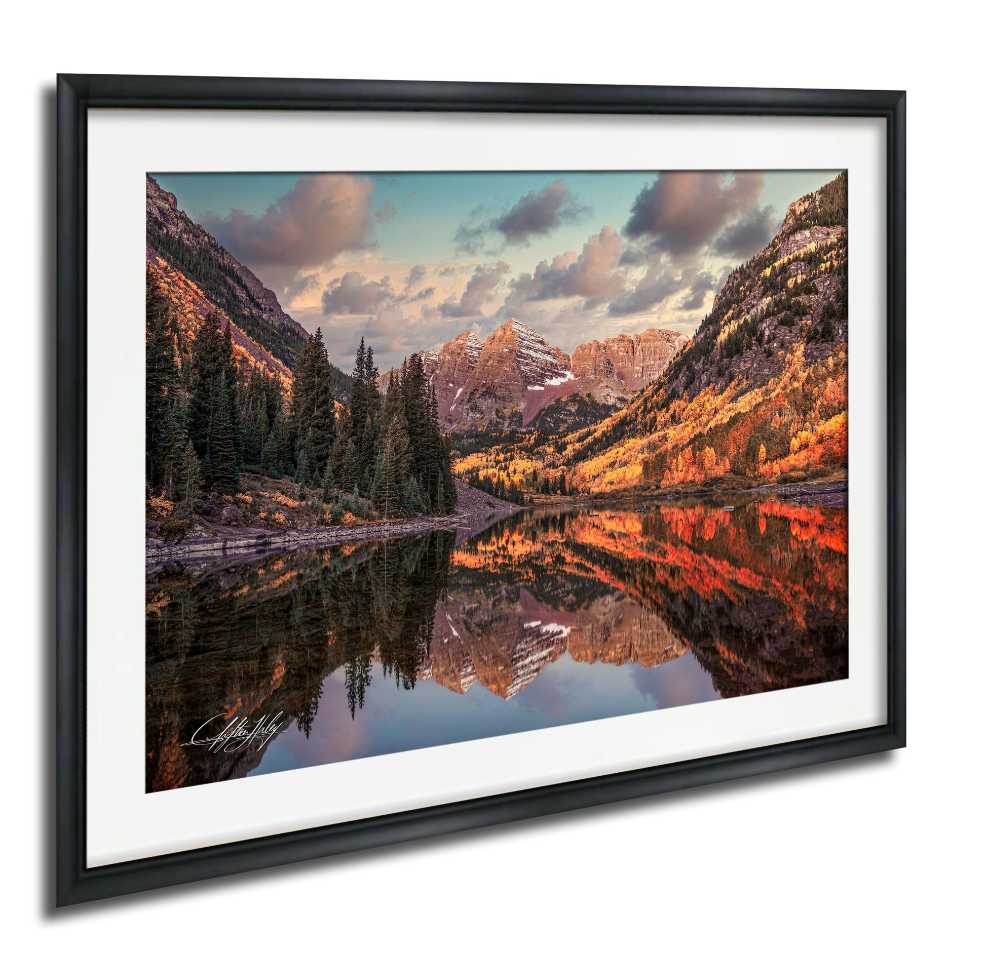 a serene mountain landscape with a lake reflecting the vibrant colors of the surrounding trees and mountains.