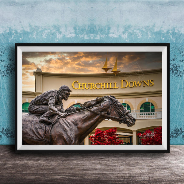 A bronze statue of a jockey riding a horse in front of a building with the sign " Churchill Downs" displayed.
