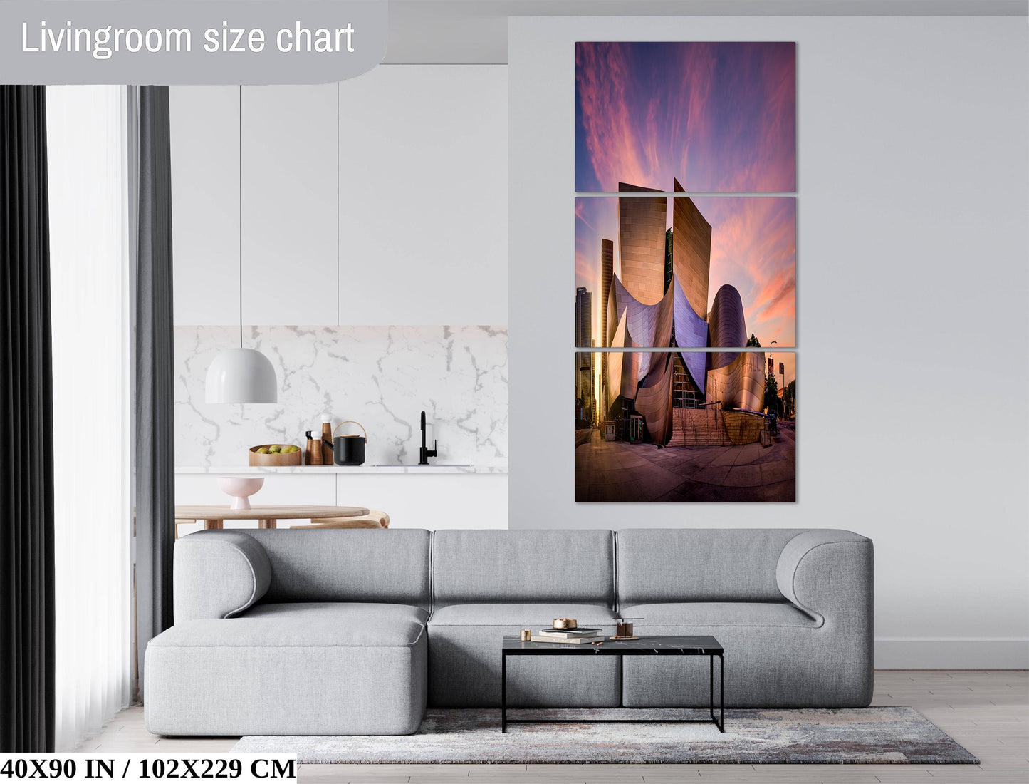 The image is a living room with a gray sofa, a coffee table, and a large wall art depicting a city skyline at sunset.
