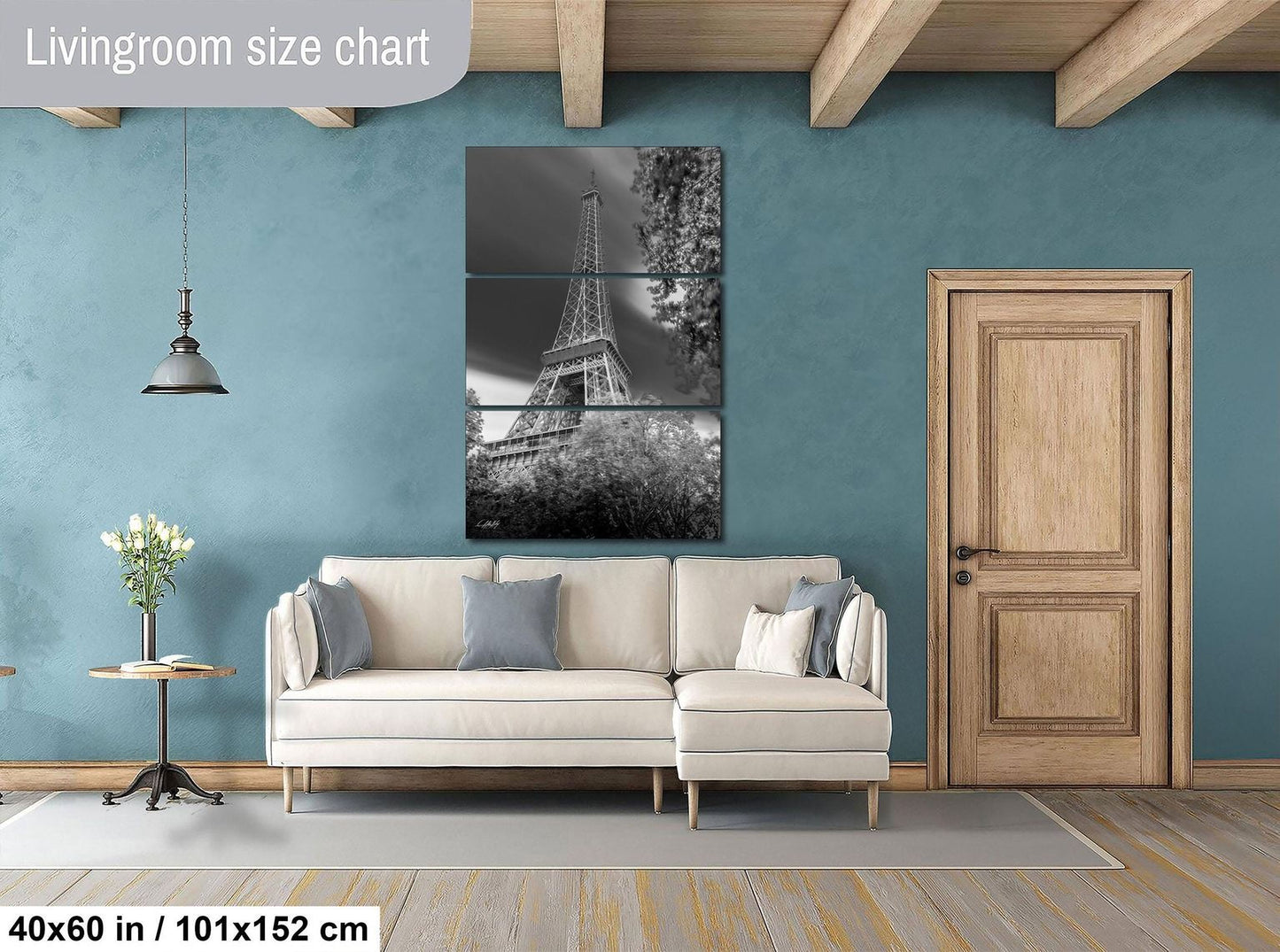 The image is a living room with a large, black and white photograph of the Eiffel Tower hanging on the wall. The room has a white sofa, a wooden door, and a small table with a vase of flowers. The living room size chart indicates the dimensions of the space, which is 40'60" in width and 101'152" in height.