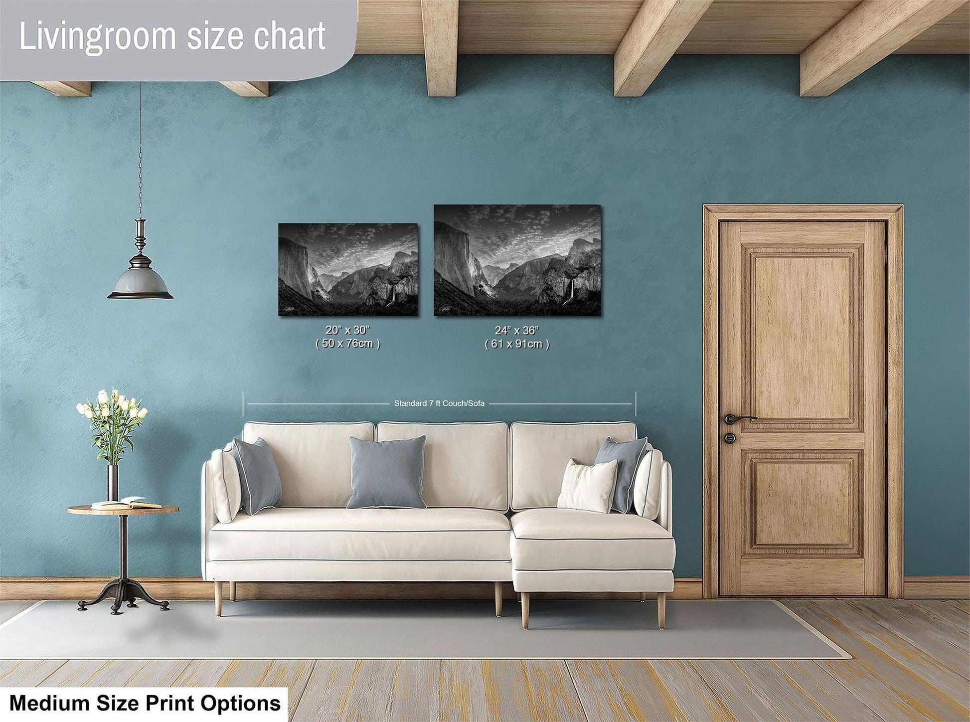 a living room with a white sofa, a wooden door, and a painting of a mountain landscape on the wall.