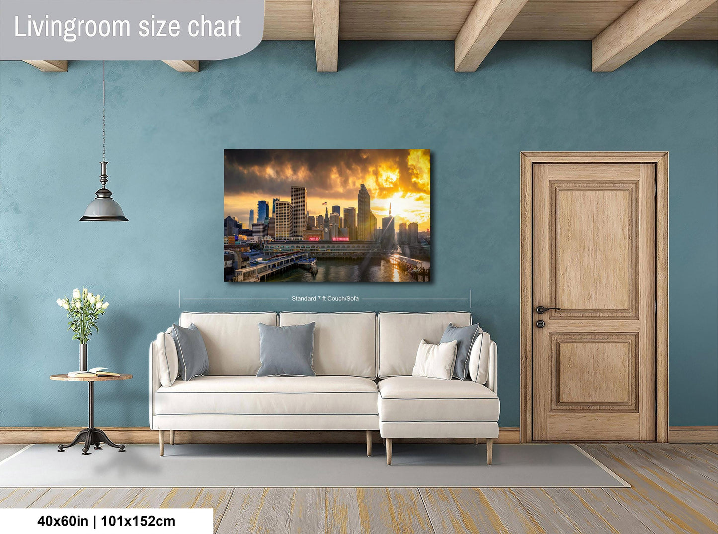 a living room with a large city skyline painting hanging on the wall. The painting features a sunset over the city skyline, creating a warm and inviting atmosphere. The living room is furnished with a white sofa and a wooden door, providing a cozy and comfortable space. The painting is approximately 40 inches wide and 115 centimeters tall, making it a prominent feature in the room.