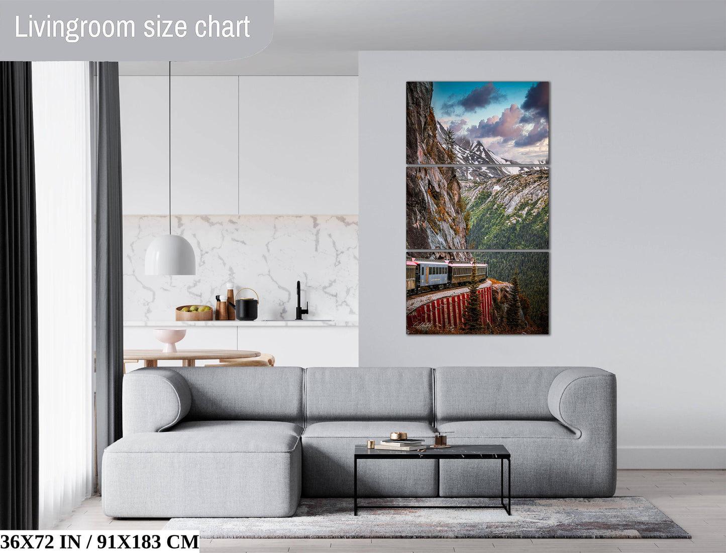 The image is a living room with a gray sofa, a coffee table, and a large wall art depicting a train on a mountain.