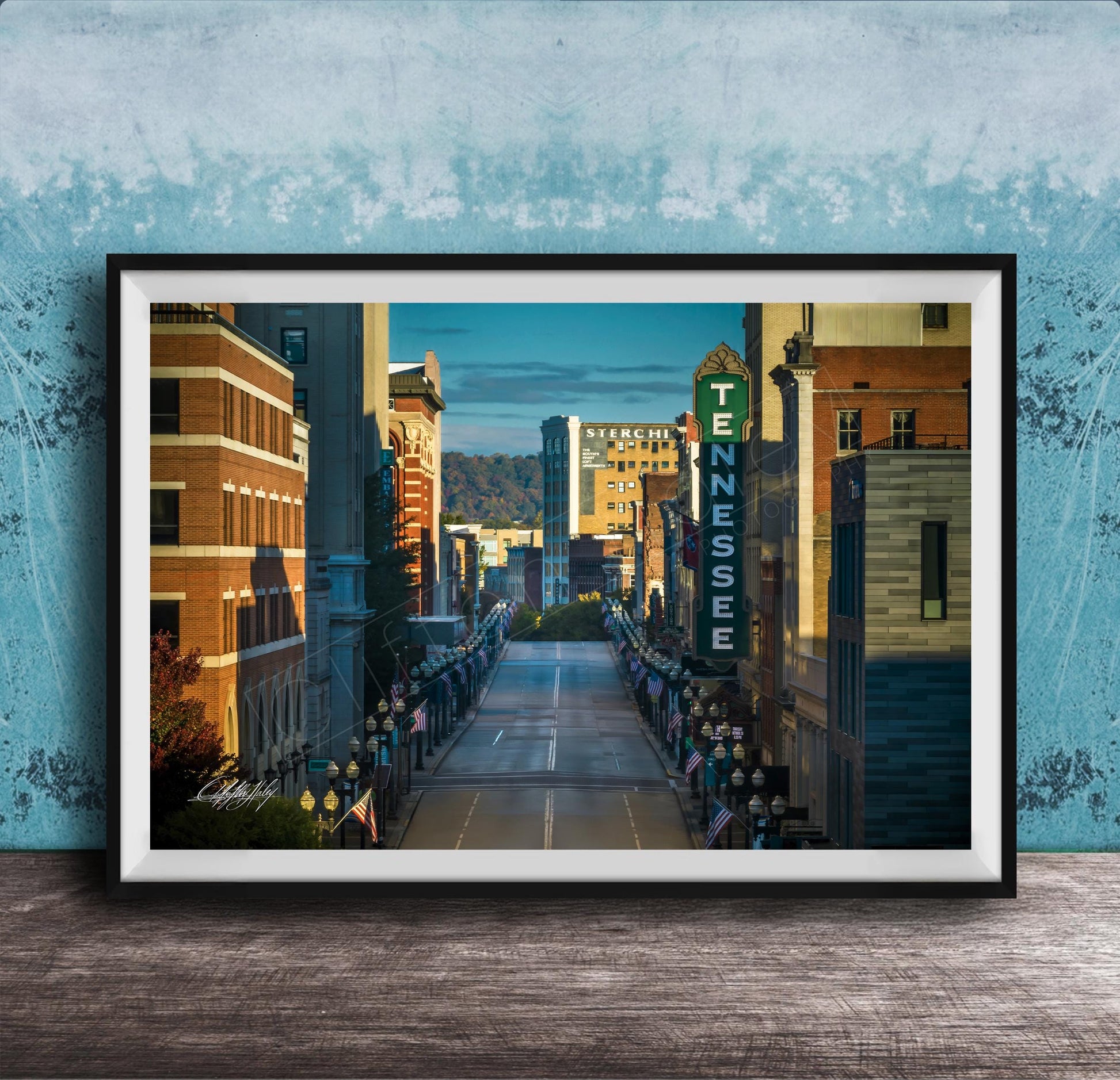 A framed photograph of a city street lined with buildings, including a prominent sign for the Tennessee Theatre.