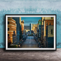 A framed photograph of a city street lined with buildings, including a prominent sign for the Tennessee Theatre.