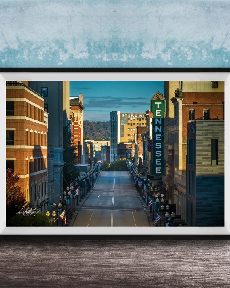 A framed photograph of a city street lined with buildings, including a prominent sign for the Tennessee Theatre.