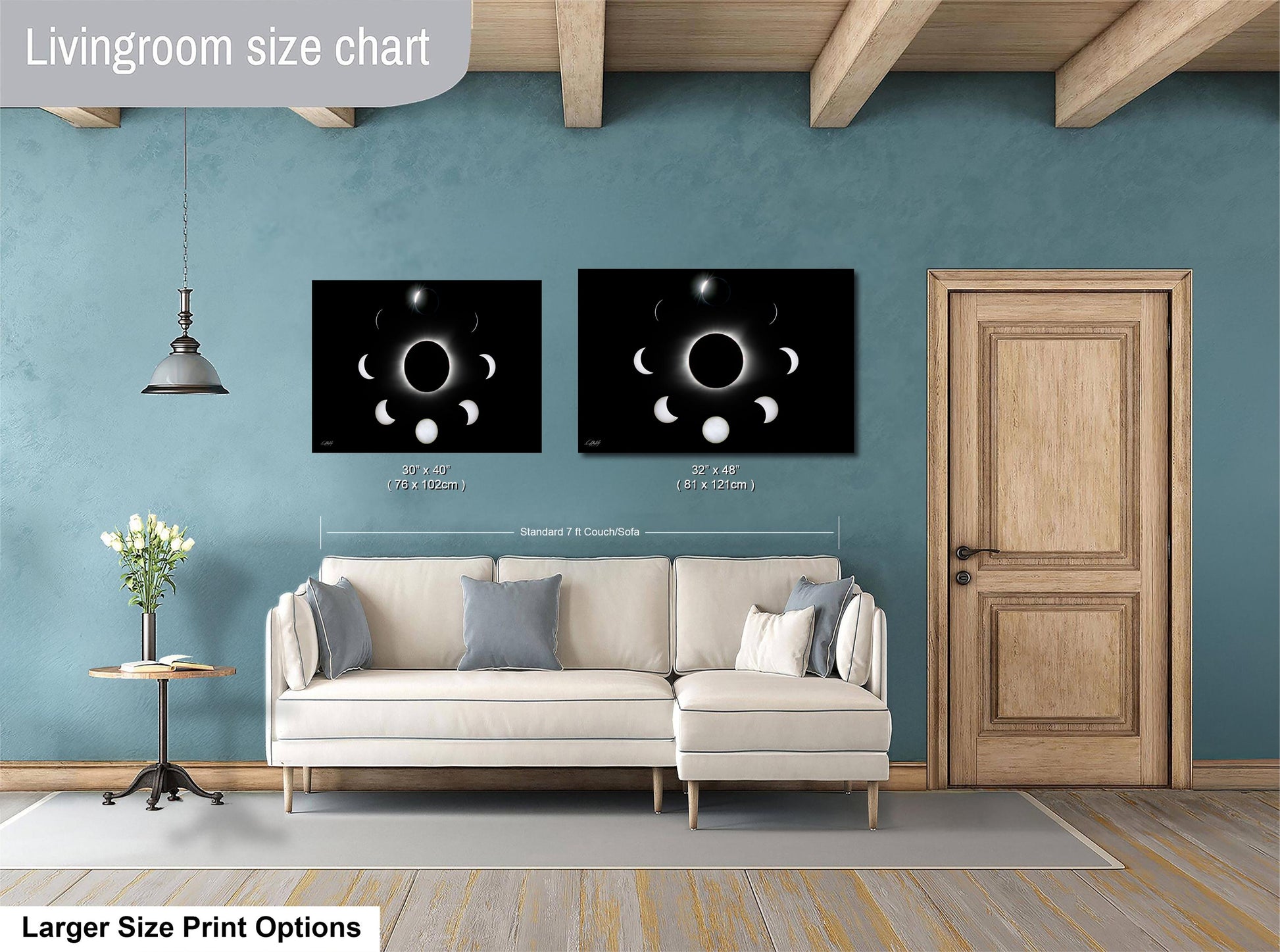 a living room with a white sofa, a wooden door, and two framed prints of the phases of the moon on the wall.