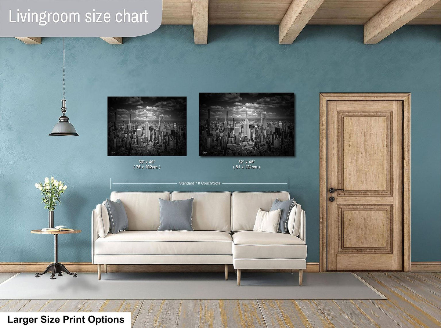 a living room with a white sofa, a wooden door, and two framed black and white cityscape paintings on the wall.