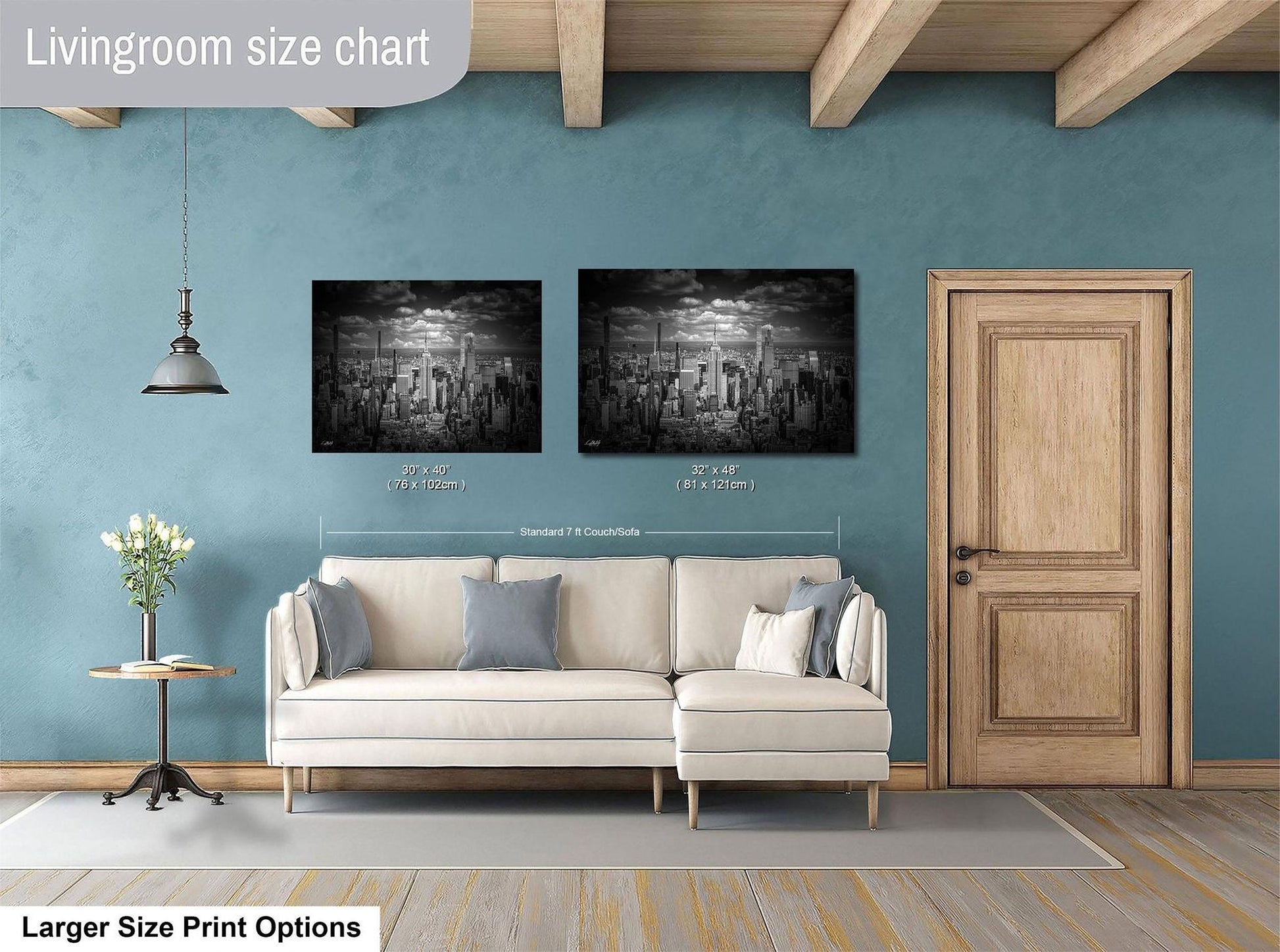a living room with a white sofa, a wooden door, and two framed black and white cityscape paintings on the wall.