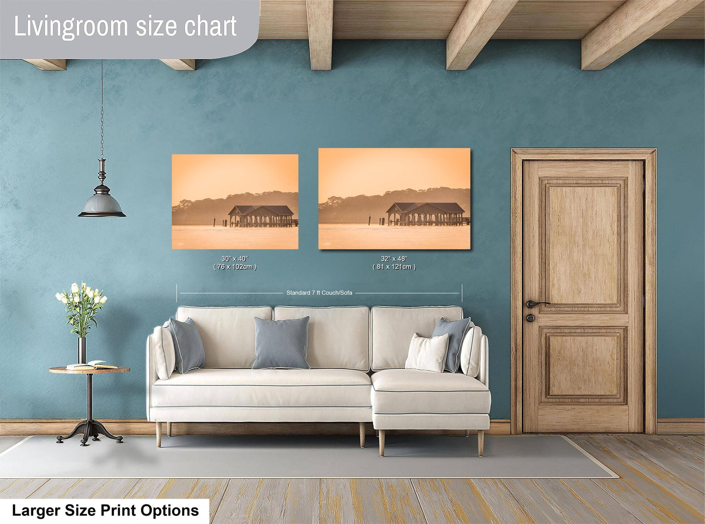 a living room with a white sofa, a wooden door, and a painting of a house on the wall. The painting is of a house with a porch, and it is displayed in two sizes: a smaller version at 30x30 inches and a larger version at 36x42 inches. The living room has a blue wall and a wooden floor.
