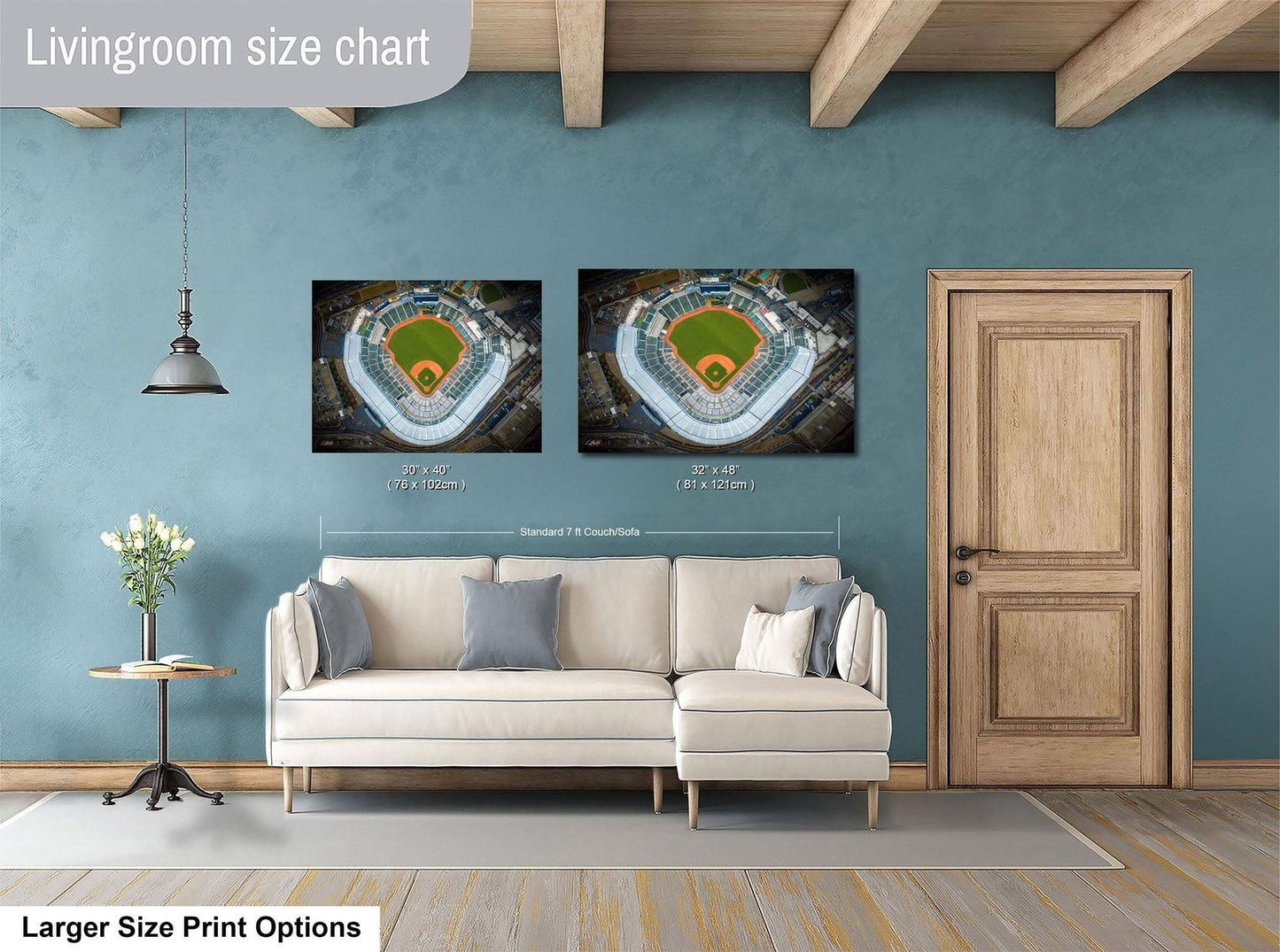 a living room with a white sofa, a wooden door, and a large wall art depicting a baseball stadium. The wall art is framed and hangs above the sofa, providing a focal point in the room.