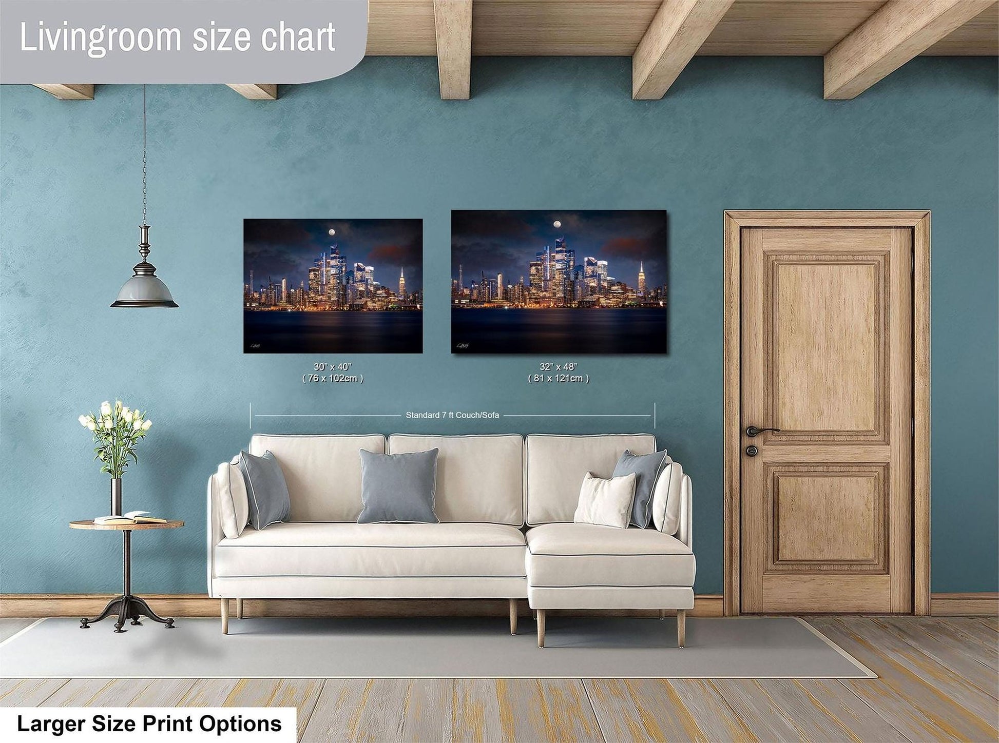 a living room with a white sofa, a wooden door, and two framed cityscape photographs hanging on the wall.