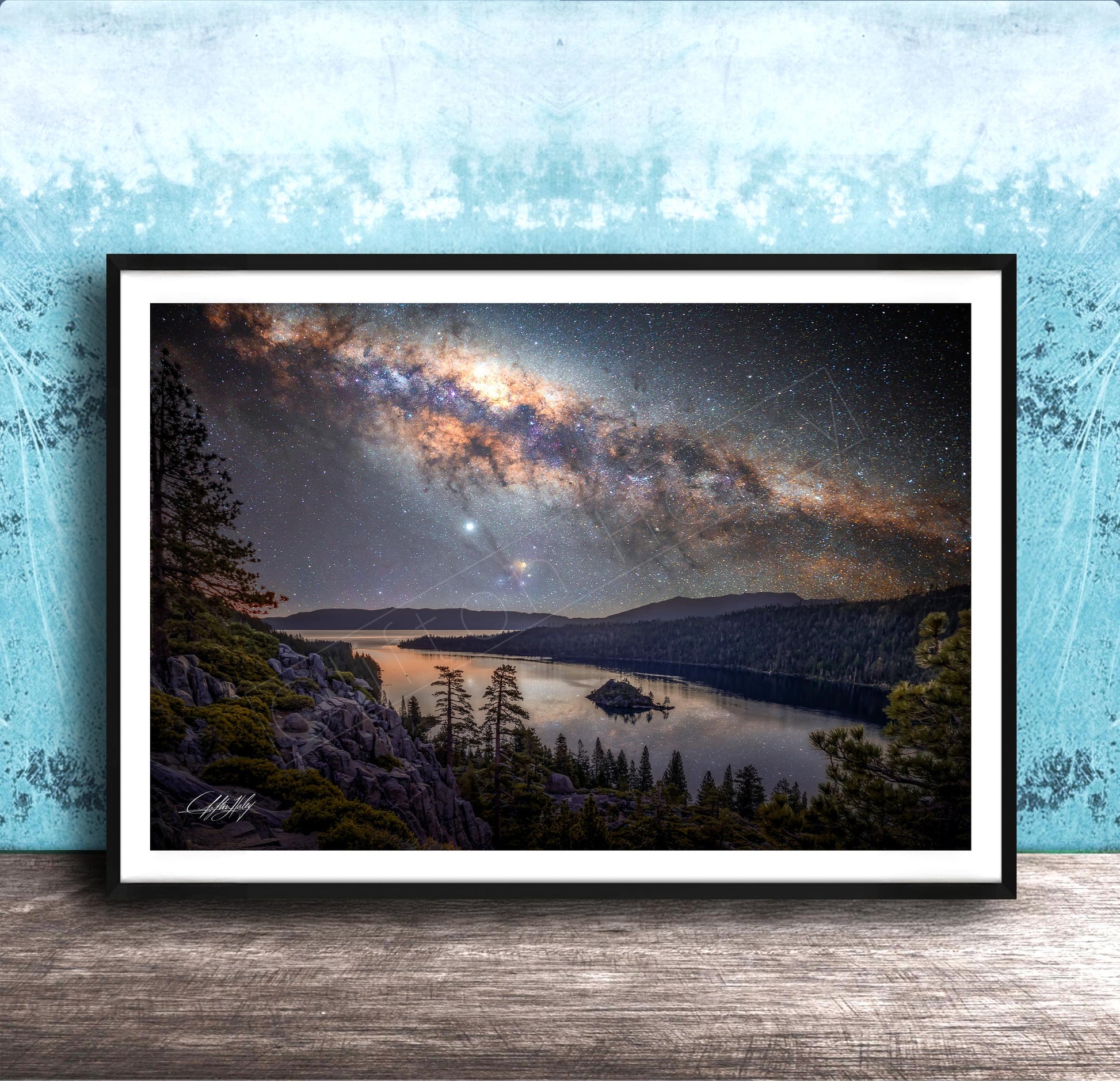 The image is a framed photograph depicting a serene night scene with a lake, mountains, and a starry sky.