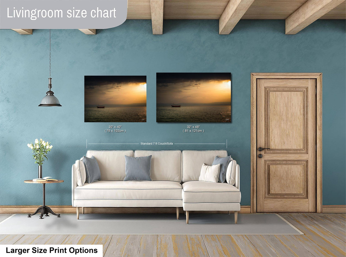 a living room with a white sofa, a wooden door, and a painting of a sunset over the ocean. The living room has a blue wall and a wooden ceiling.