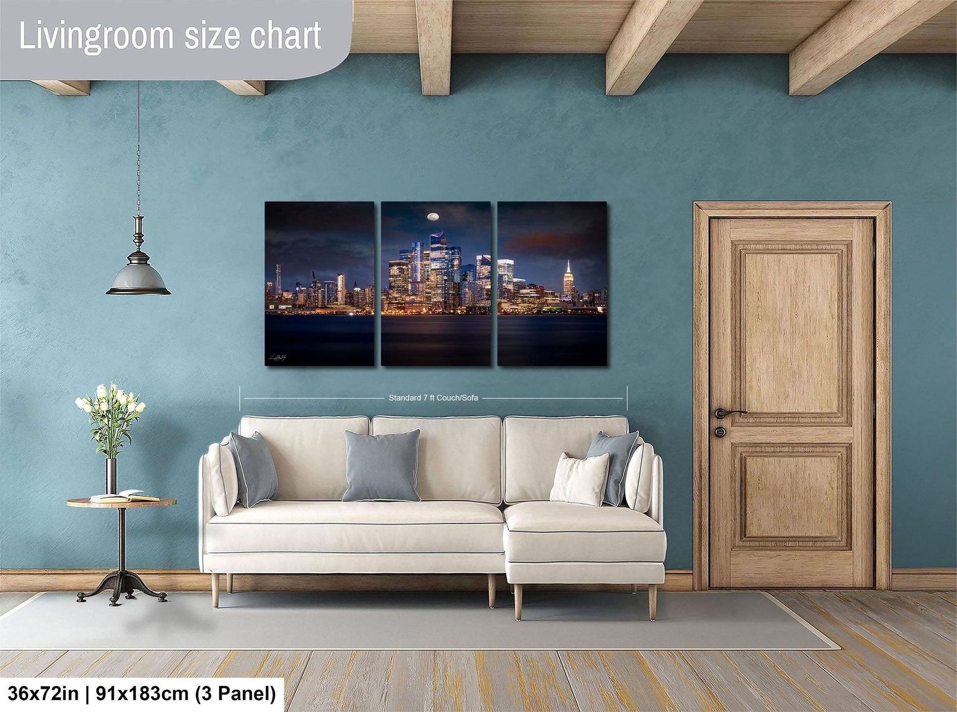 The image is a living room with a large wall art depicting a city skyline at night. The wall art is divided into three panels, with the largest panel covering the entire wall. The room features a white sofa, a wooden door, and a small table with a vase of flowers. The living room size chart indicates that the space is approximately 36 square meters.