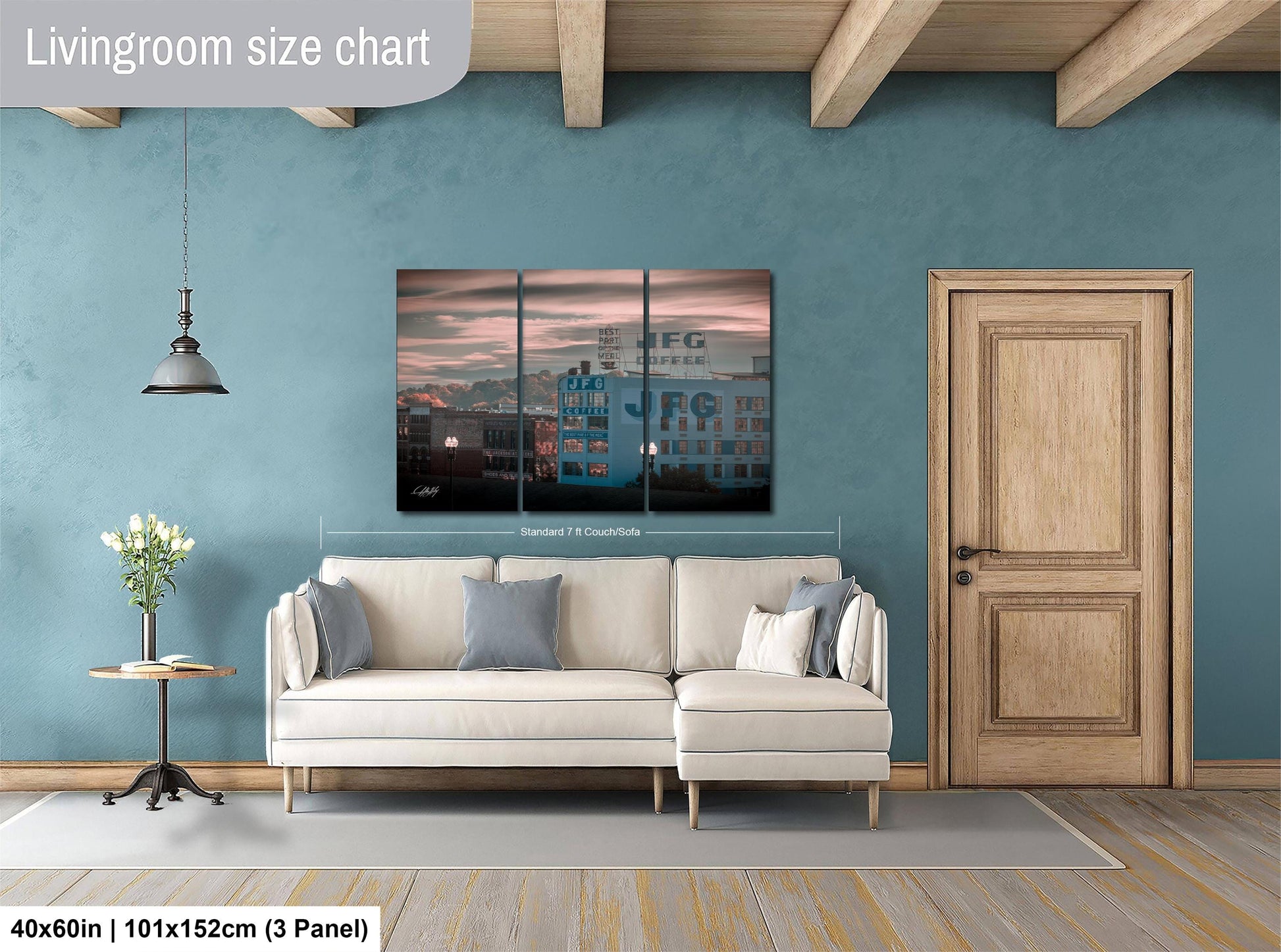 The image is a living room with a white sofa, a wooden door, and a large wall art depicting a cityscape. The wall art is a collage of three panels, and the living room is described as having a blue wall and a wooden floor.