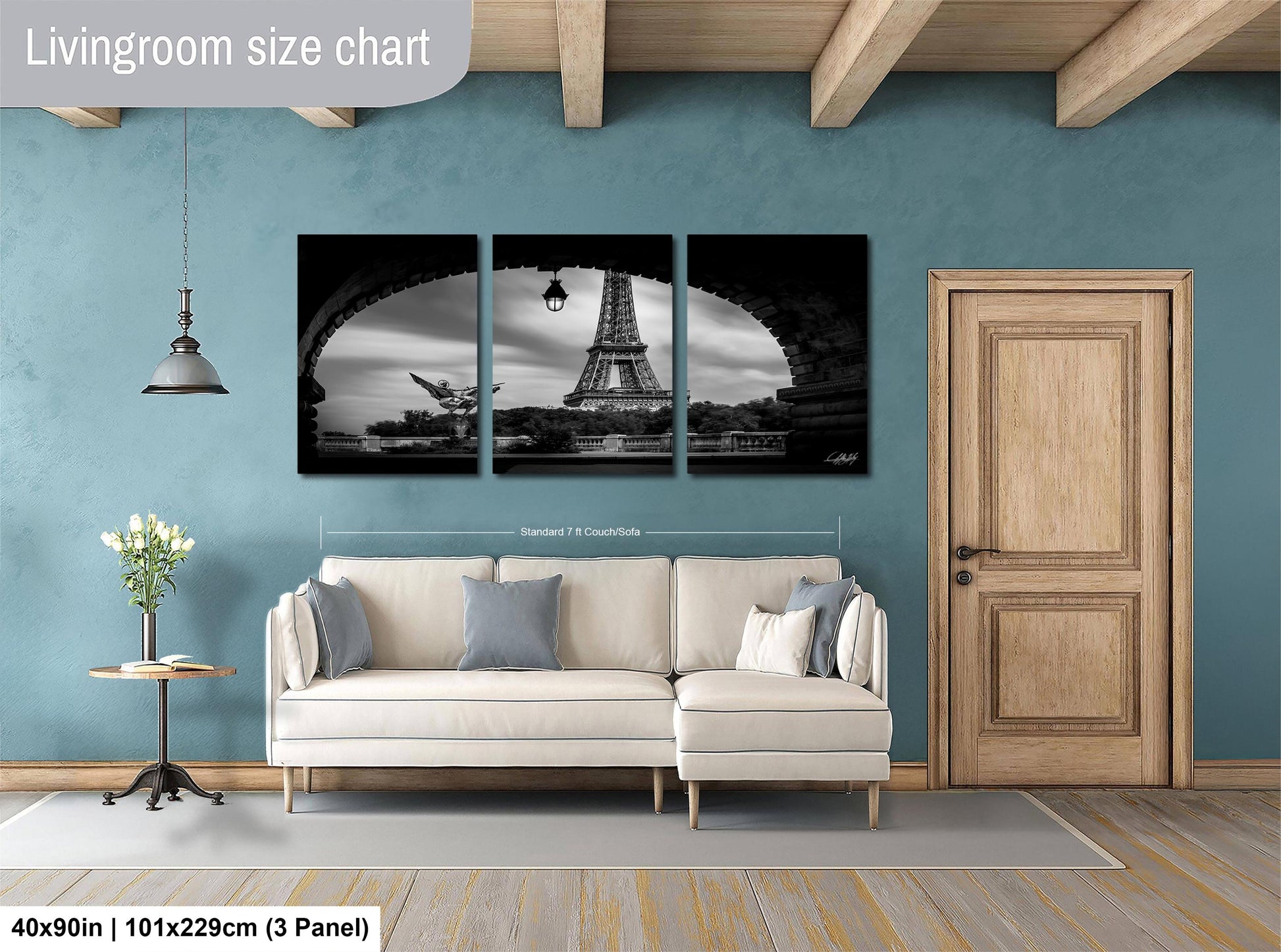 The image is a living room with a large, black and white photograph of the Eiffel Tower as the focal point. The room is furnished with a white sofa and a wooden door. The living room size chart indicates that the space is approximately 40'x50' in width and 101'x129' cm in height.