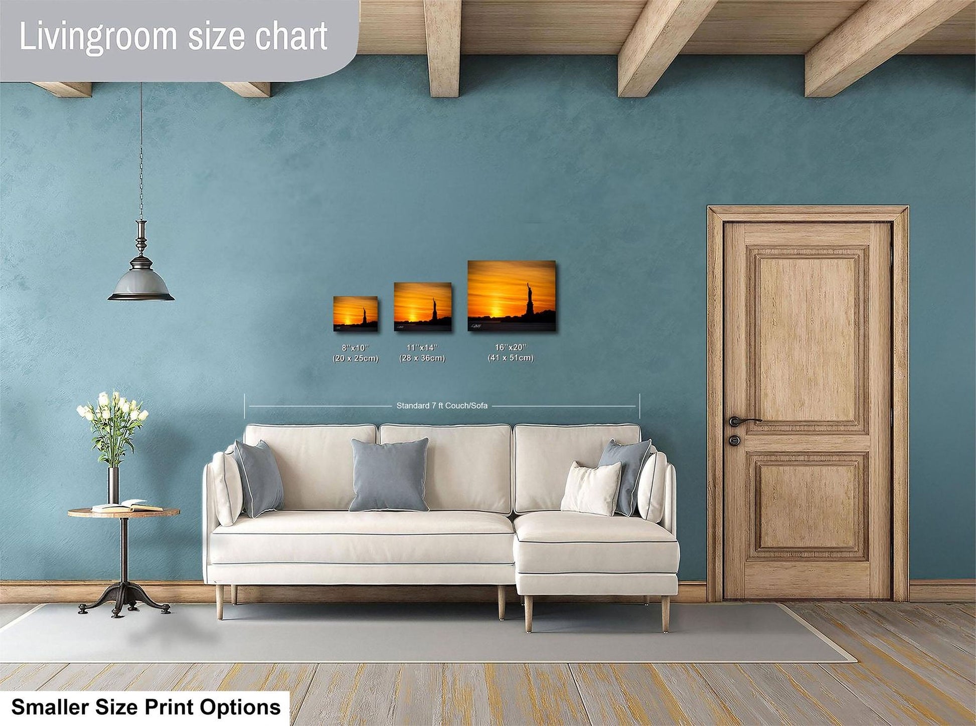 a living room with a white sofa, a wooden door, and a hanging light fixture. There are three framed pictures hanging on the wall above the sofa, and the text indicates that the living room is designed for smaller size print options.