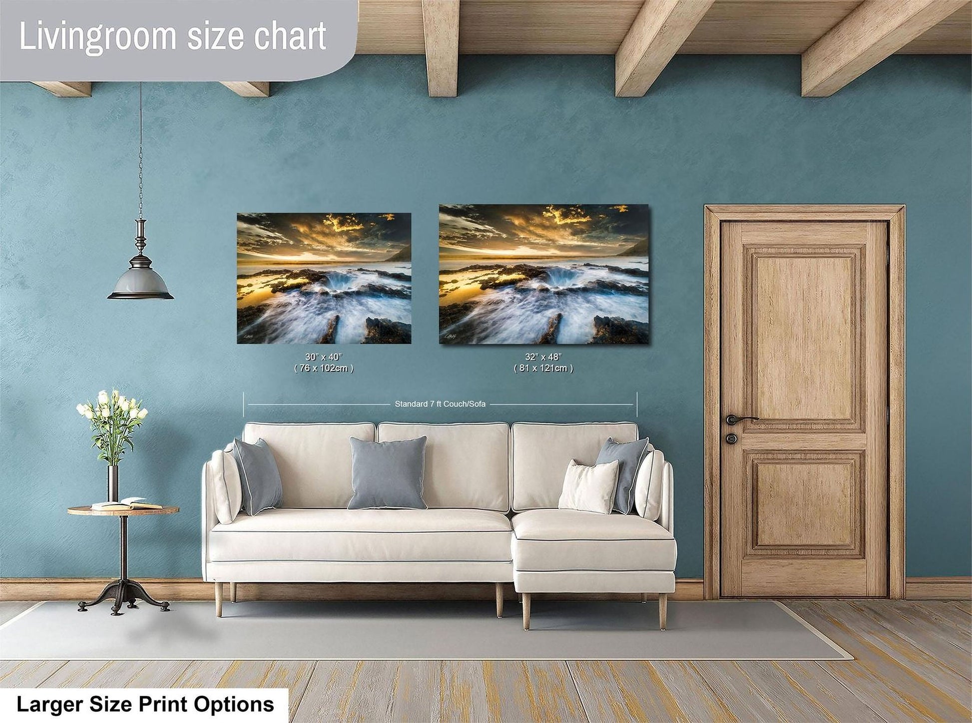 a living room with a white sofa, a wooden door, and two framed landscape paintings hanging on the wall.