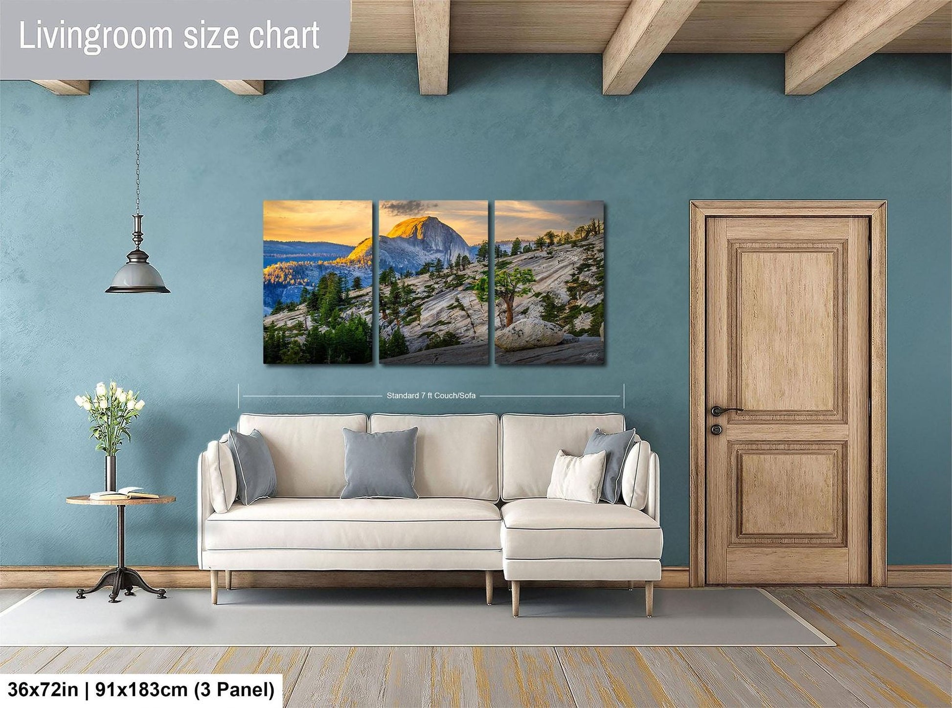 The image is a living room with a large wall art depicting a scenic mountain landscape. The wall art is divided into three panels, with the largest panel covering the entire wall. The room features a white sofa, a wooden door, and a small table with a vase of flowers. The living room size chart indicates that the space is approximately 36 square meters.