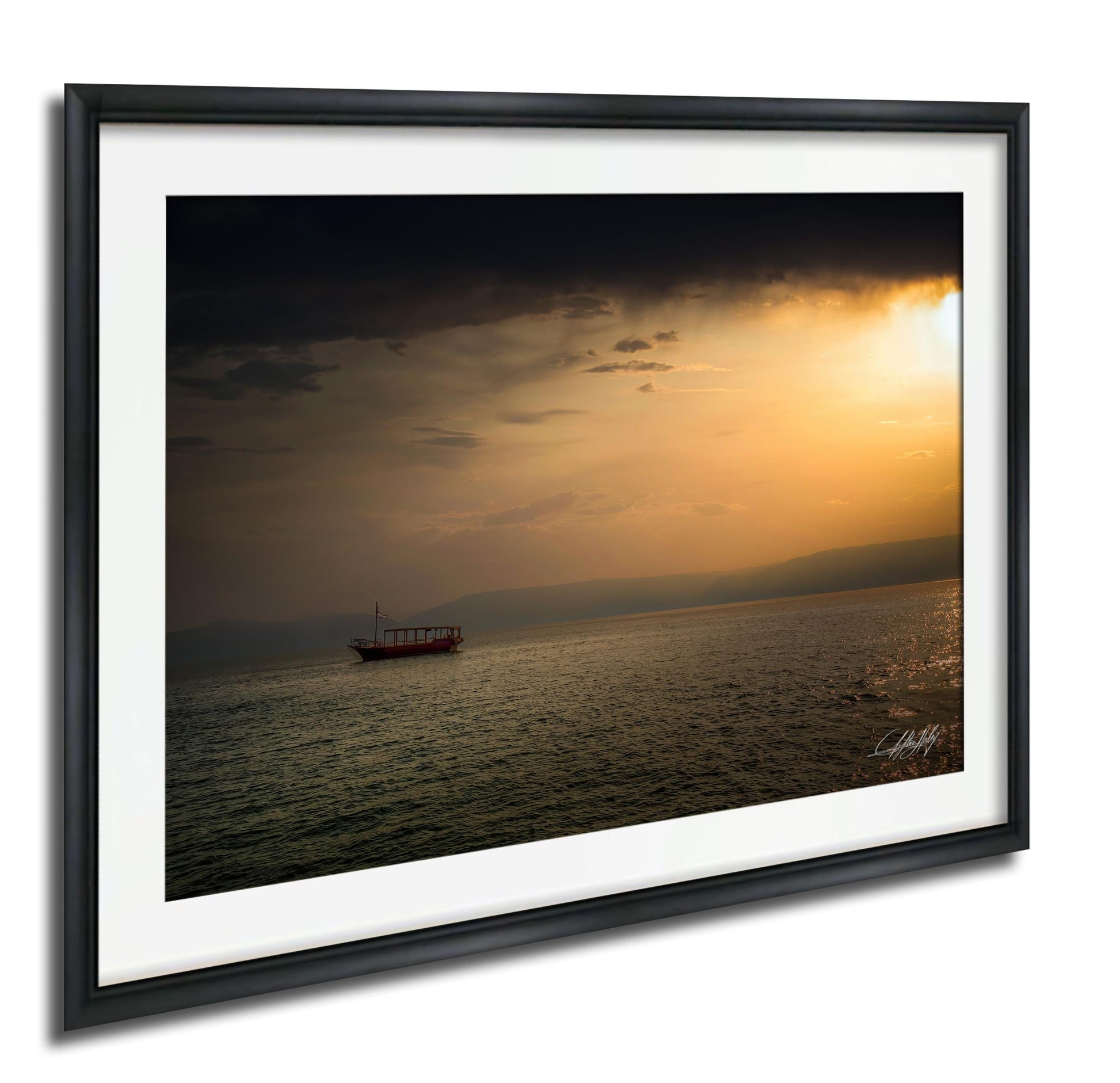 A boat is sailing on a calm body of water under a dramatic sky at sunset.