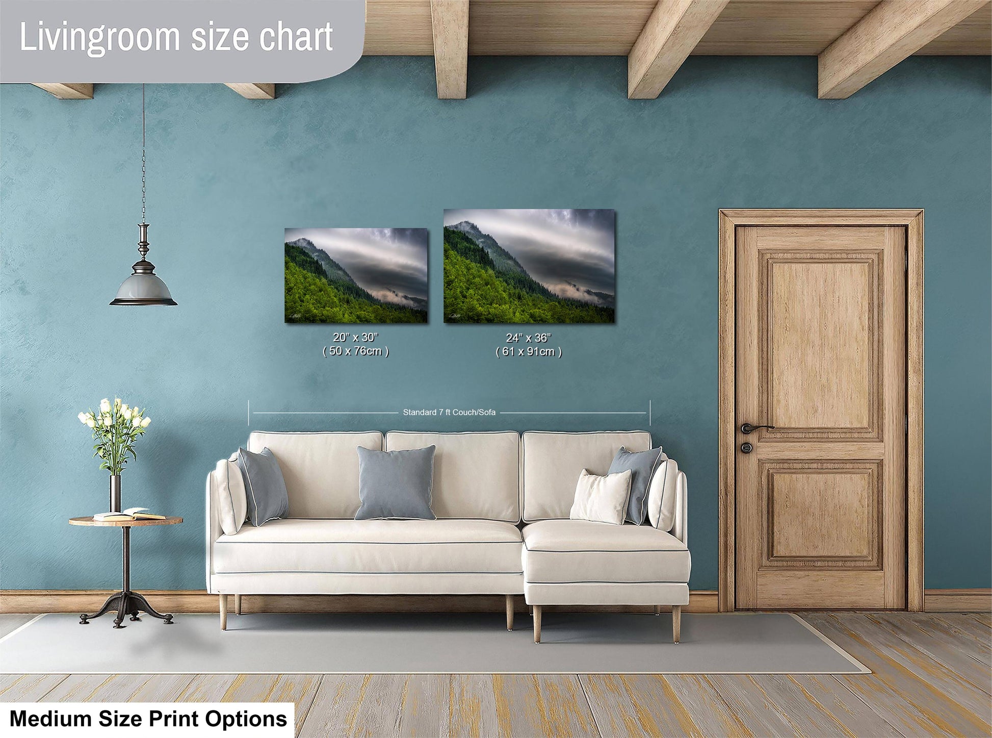 a living room with a white sofa, a wooden door, and a painting of a mountain landscape on the wall.
