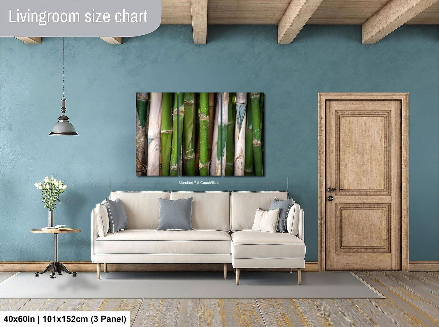 a living room with a white sofa, a wooden door, and a painting of bamboo on the wall.