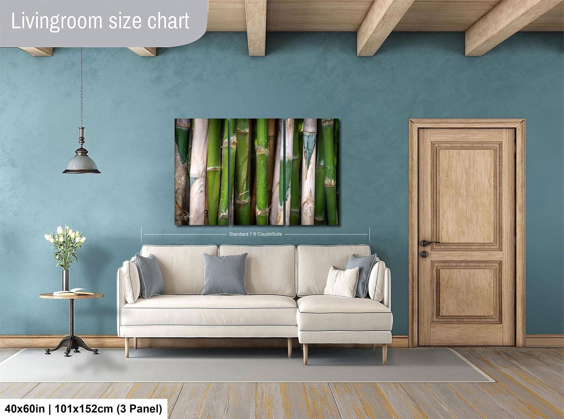 a living room with a white sofa, a wooden door, and a painting of bamboo on the wall.
