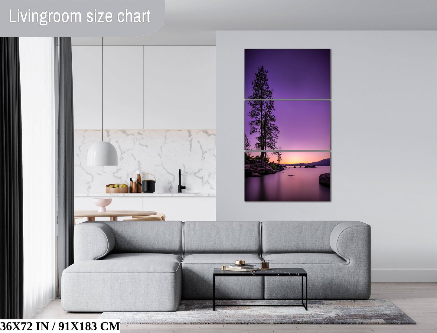 The image is a living room with a gray sofa, a coffee table, and a large wall art depicting a sunset over a lake.