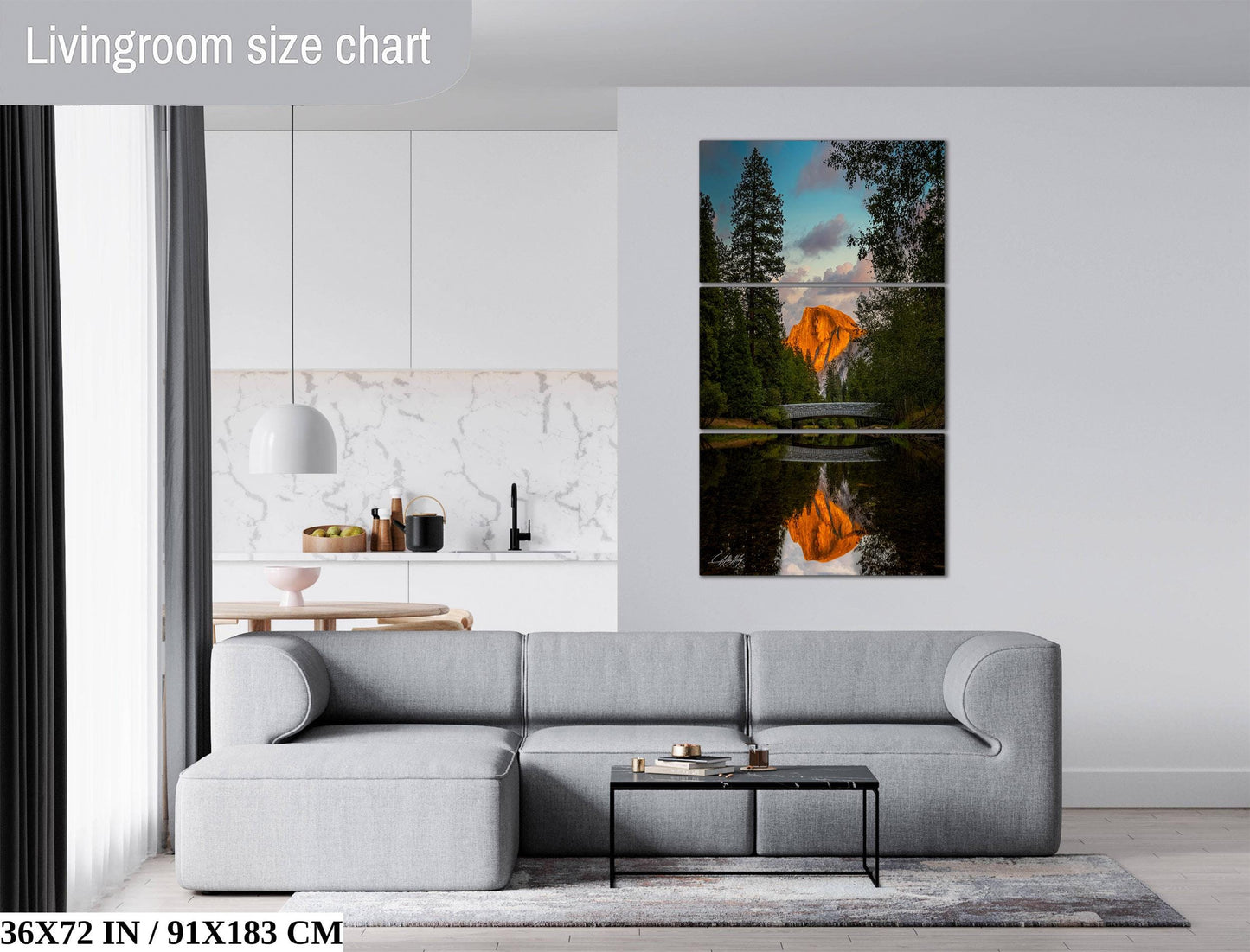The image is a living room with a gray sofa, a coffee table, and a large wall art depicting a scenic landscape with a sunset over a lake.