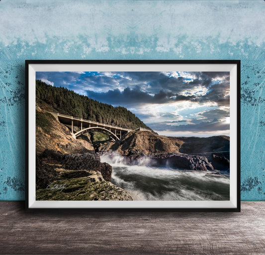 a scenic view of a bridge spanning over a rushing river, with a dramatic sky and lush green trees in the background.