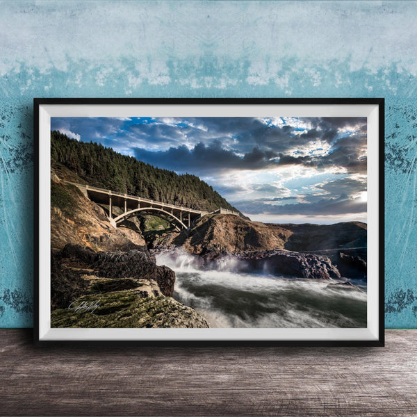 a scenic view of a bridge spanning over a rushing river, with a dramatic sky and lush green trees in the background.