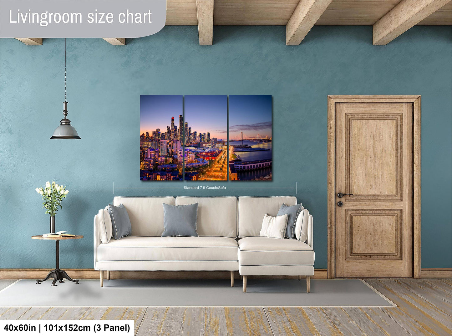 The image is a living room with a large city skyline painting hanging on the wall. The painting is divided into three panels, and the wall is painted in a light blue color. There is a white sofa and a wooden door in the room.