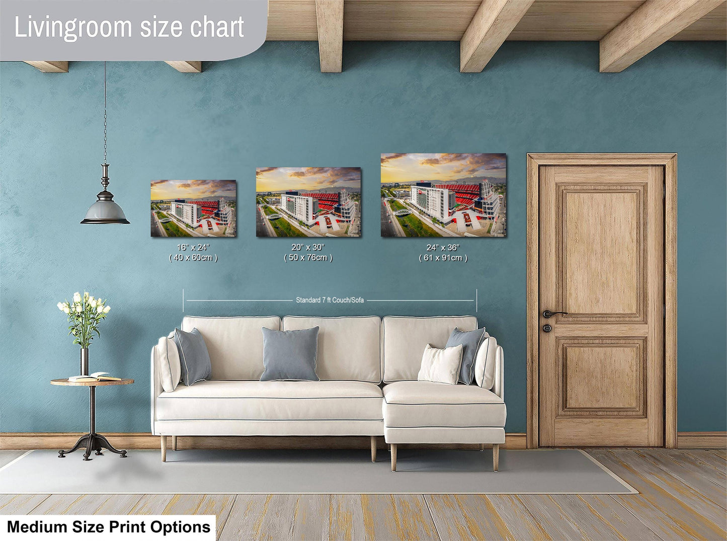 a living room with a white sofa and a wooden door. Above the sofa, there is a livingroom size chart that provides the dimensions of three different paintings or prints displayed on the wall.