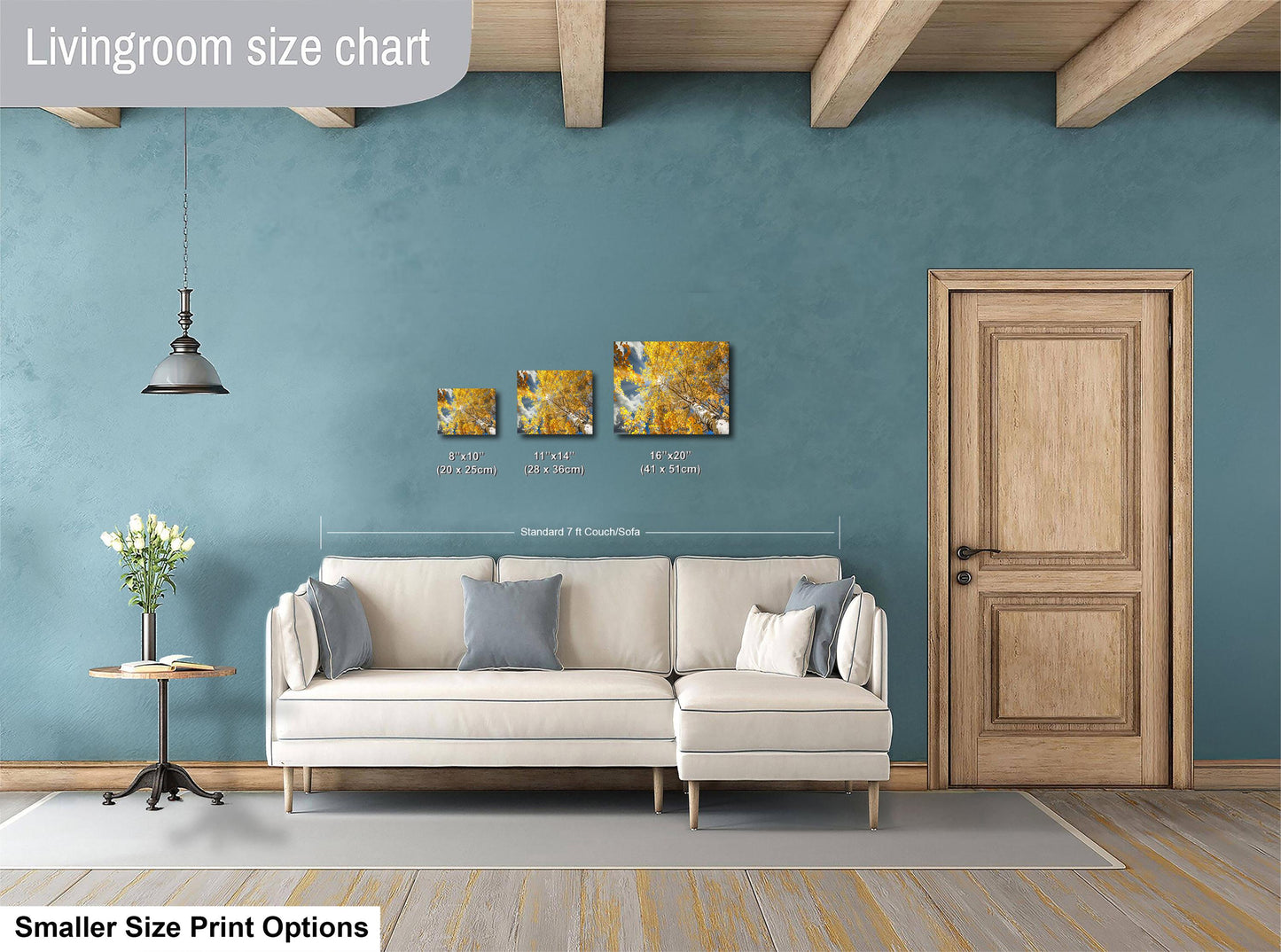a living room with a white sofa, a wooden door, and a painting on the wall. The sofa is positioned in front of the door, and there is a lamp hanging from the ceiling. The painting is displayed on the wall above the sofa.