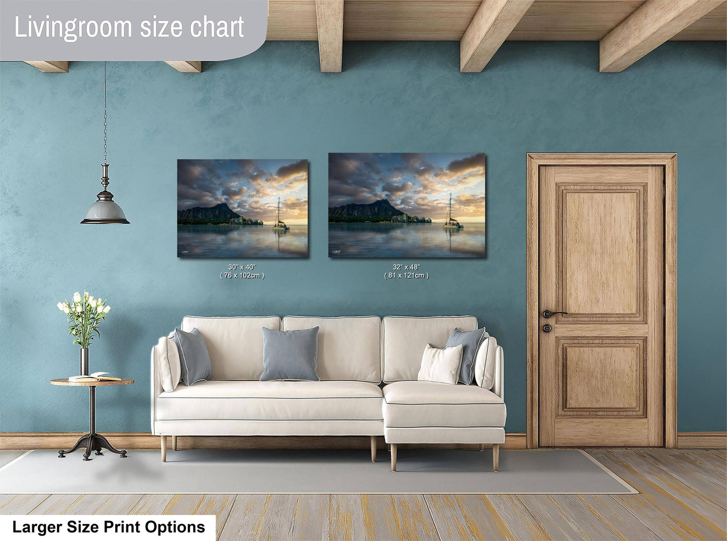 a living room with a white sofa, a wooden door, and two framed pictures of a sunset over a body of water.