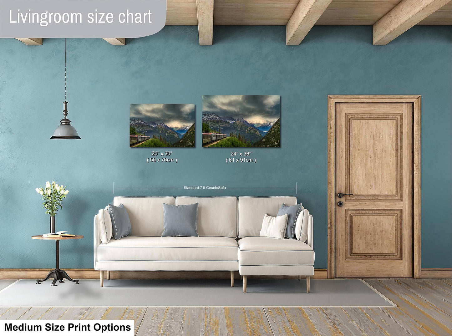 a living room with a white sofa, a wooden door, and a painting of a mountain landscape on the wall.