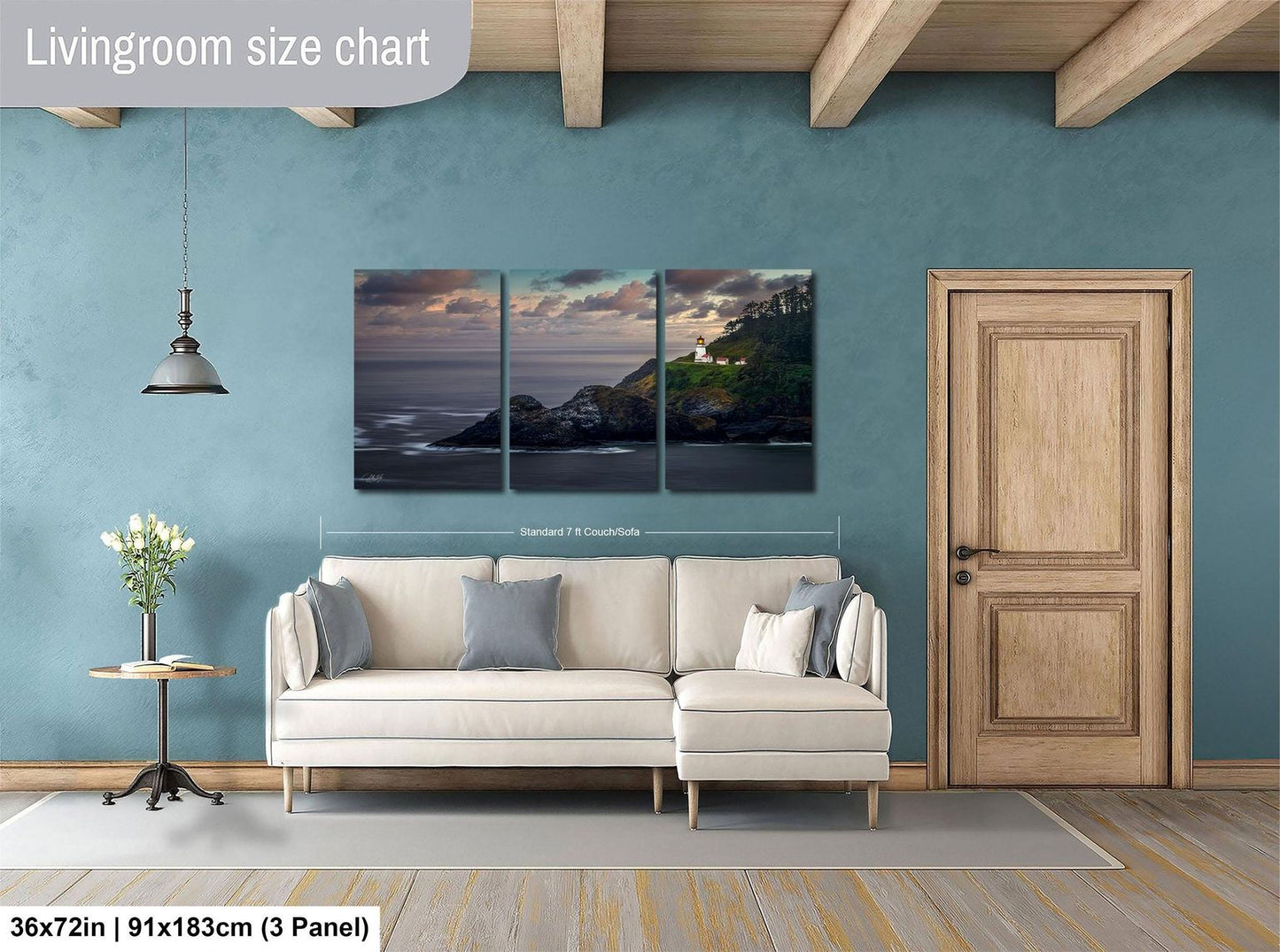 The image is a living room with a large, three-panel landscape painting hanging on the wall. The painting depicts a serene coastal scene with a lighthouse on a cliff. The room is furnished with a white sofa and a wooden door, creating a cozy and inviting atmosphere.
